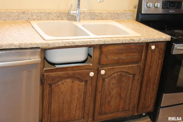 a view of a bathroom with a sink and a mirror