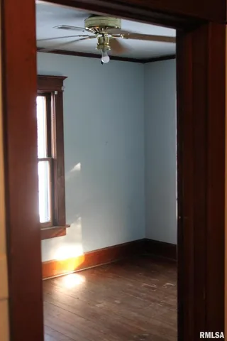 an empty room with wooden floor and closet