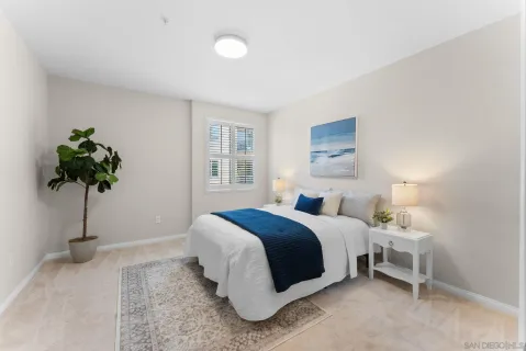 a bedroom with a bed and a potted plant