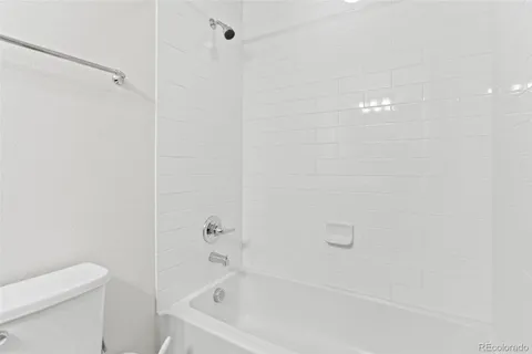 a bathroom with a bathtub and a toilet