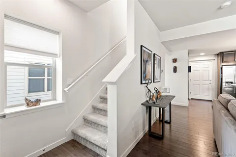 a view of an entryway with wooden floor and windows