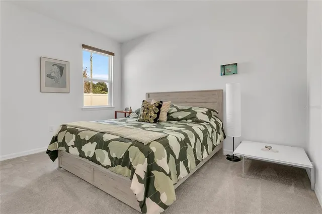 a bedroom with a bed and window