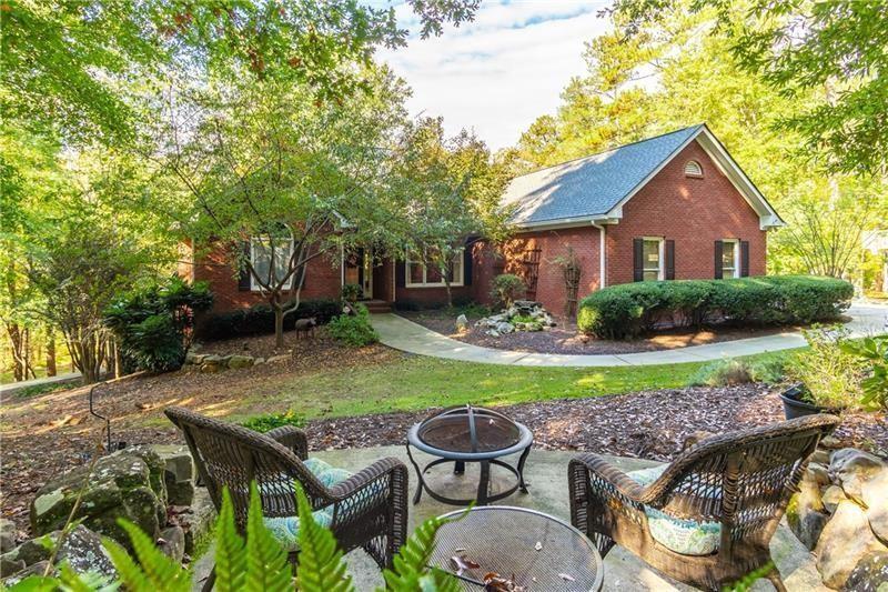 3398 Rising Fawn Trail Suwanee, GA 30024 - Photo 1 of 1 Relaxing waterfall and pond welcome you home. Amazing hardscapes and firepits in front and back.