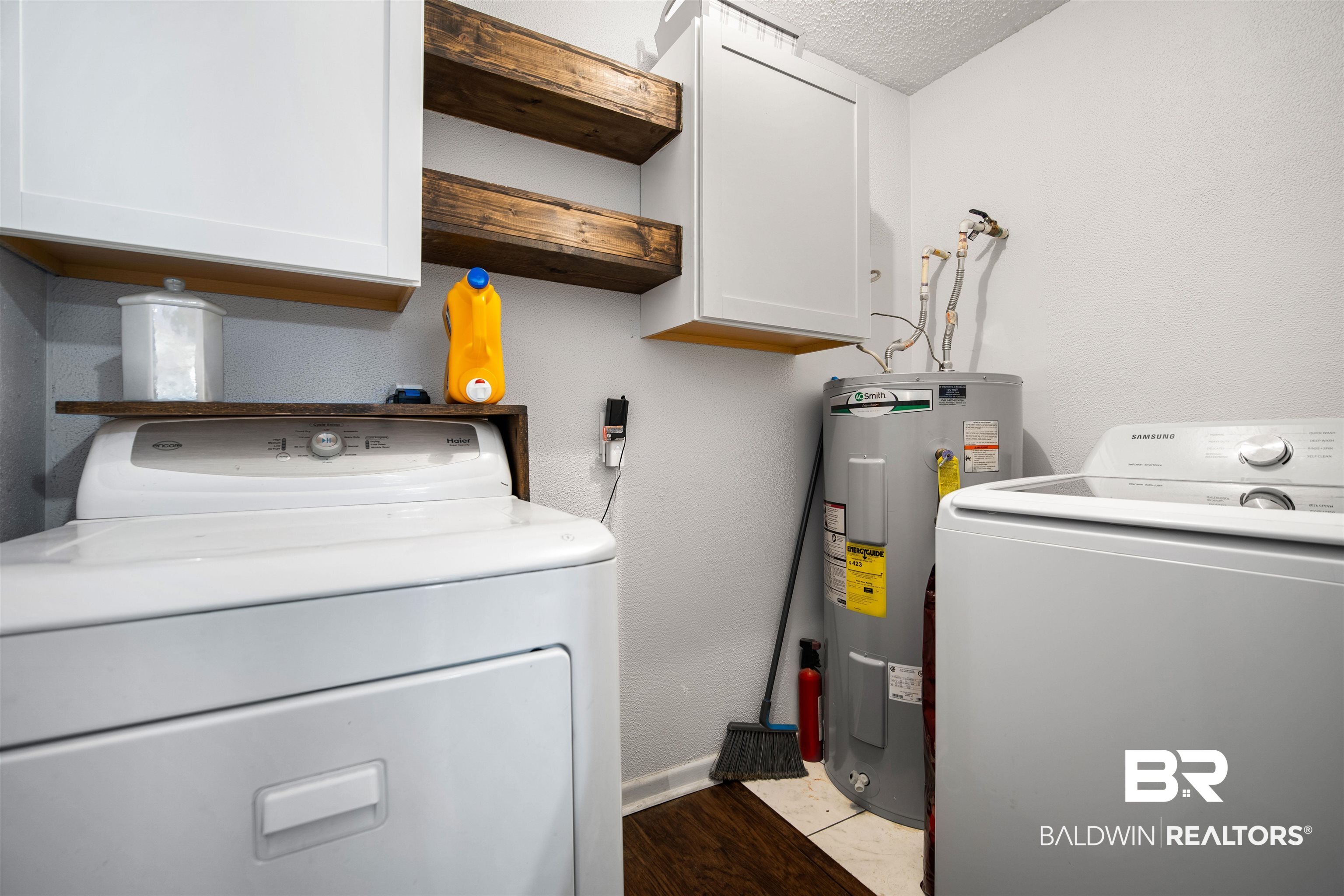 5110 Wilmer Road Wilmer, AL 36587 - Photo 20 of 24 Washroom featuring cabinets, a textured ceiling, washing machine and clothes dryer, and water heater