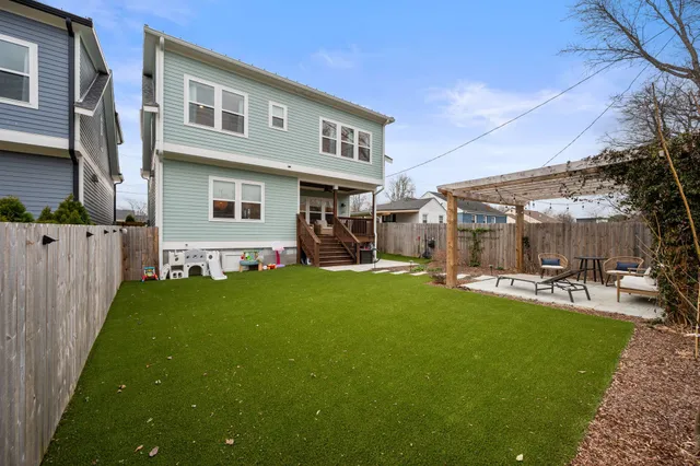 a view of a house with backyard porch and sitting area