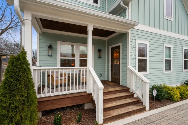 a view of a house with deck and backyard