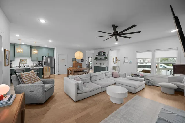a living room with furniture ceiling fan and a rug