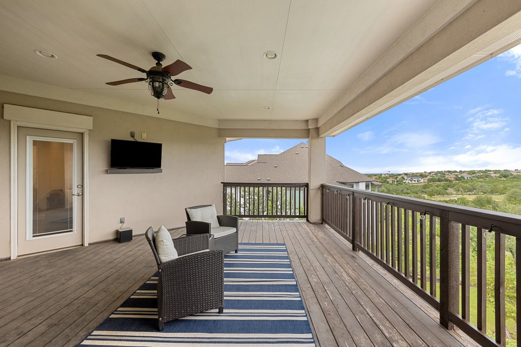 215 Lodestone Lane Austin, TX 78738 - Photo 28 of 40 An inviting covered balcony with a refreshing ceiling fan overlooks scenic hills.