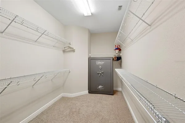 a view of a hallway with wooden floor and a livingroom