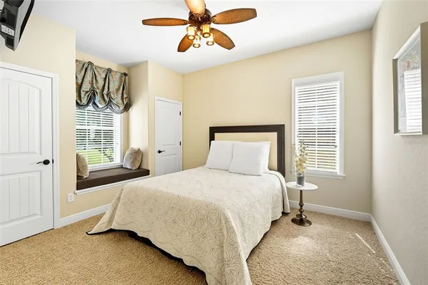 a bathroom with a granite countertop sink a toilet and a mirror