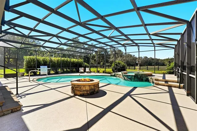 an aerial view of green landscape with trees houses and mountain view
