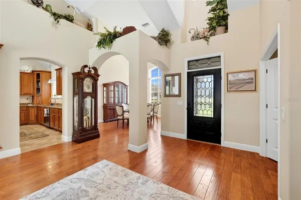 a view of living room kitchen and entryway