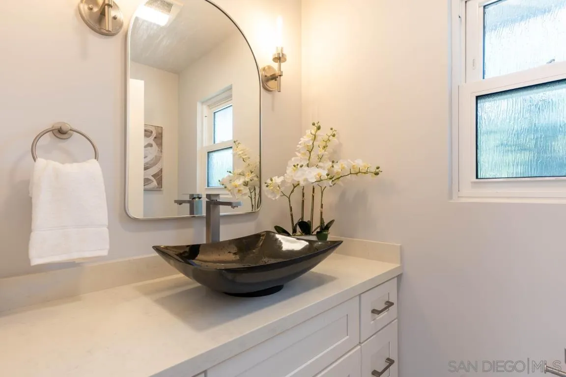 907 Ridge Heights Drive Fallbrook, CA 92028 - Photo 46 of 70 a view of a bathroom with a sink and mirror