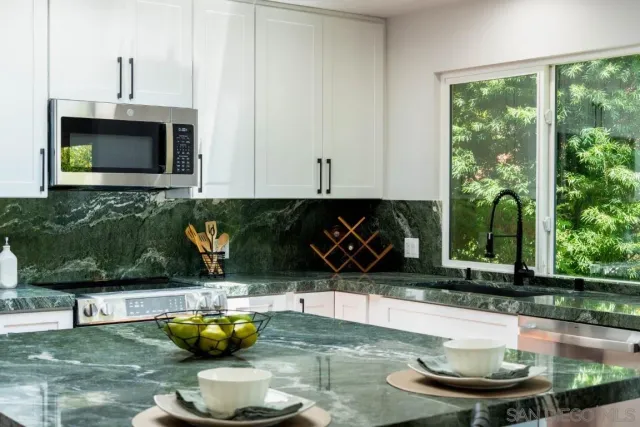 a kitchen with a table and chairs in it