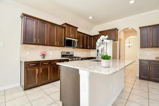 a kitchen with stainless steel appliances granite countertop a refrigerator sink and cabinets
