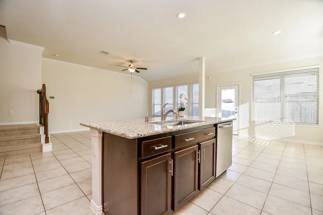 a kitchen with stainless steel appliances granite countertop a sink and a stove