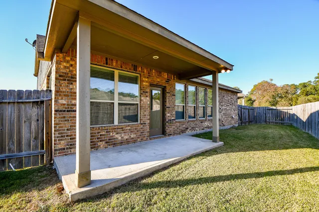 a view of house with backyard