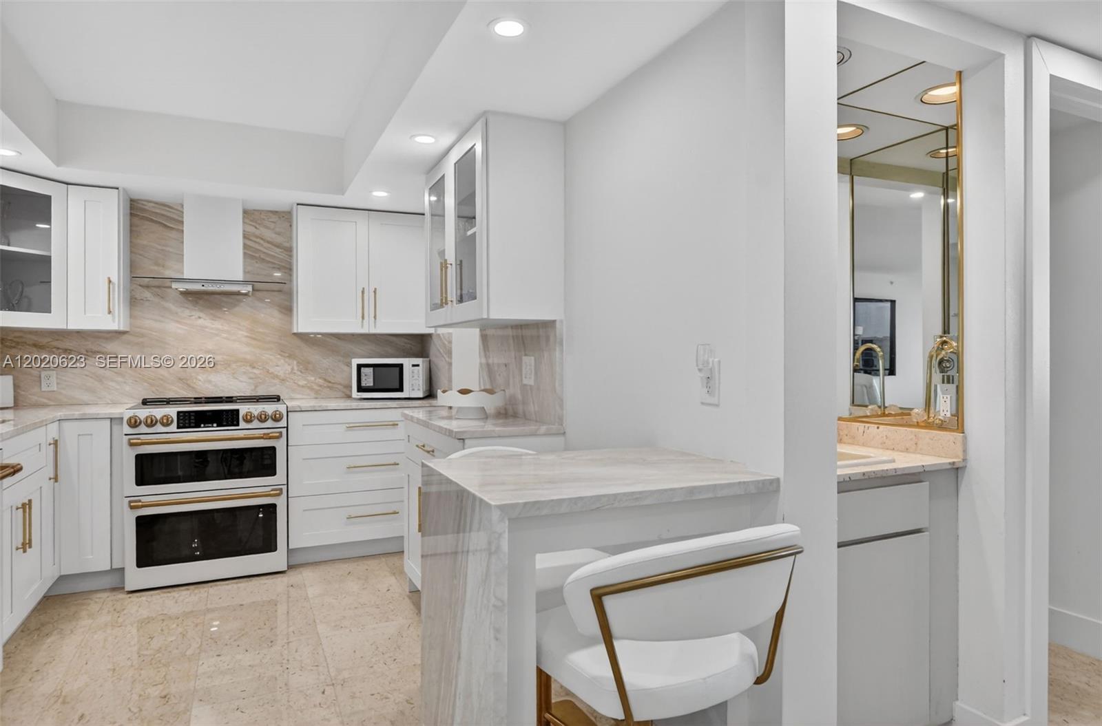 4101 North Ocean Boulevard, Unit 1605 Boca Raton, FL 33431 - Photo 4 of 35 a kitchen with a stove a sink and a refrigerator
