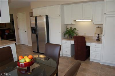 7840 Ferguson Road Kent, OH 44240 - Photo 11 of 25 Another view of kitchen with built in desk. Kitchen appliances stay!