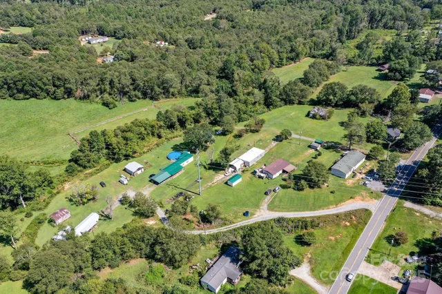 an aerial view of a residential houses with outdoor space