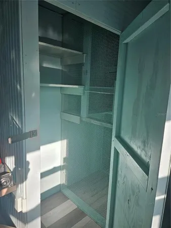 an empty room with wooden floor and entryway