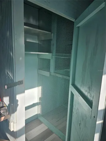 an empty room with wooden floor and entryway