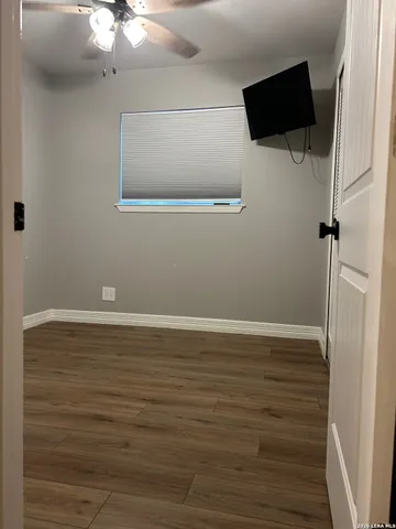 a room with a wooden floor and shoes