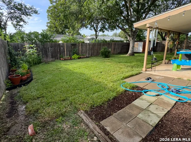 a view of a backyard with sitting area