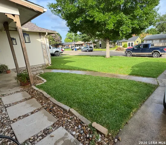 a view of a back yard with a wooden door