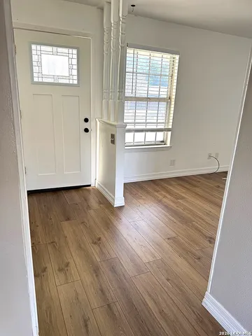 a view of a room with wooden floor