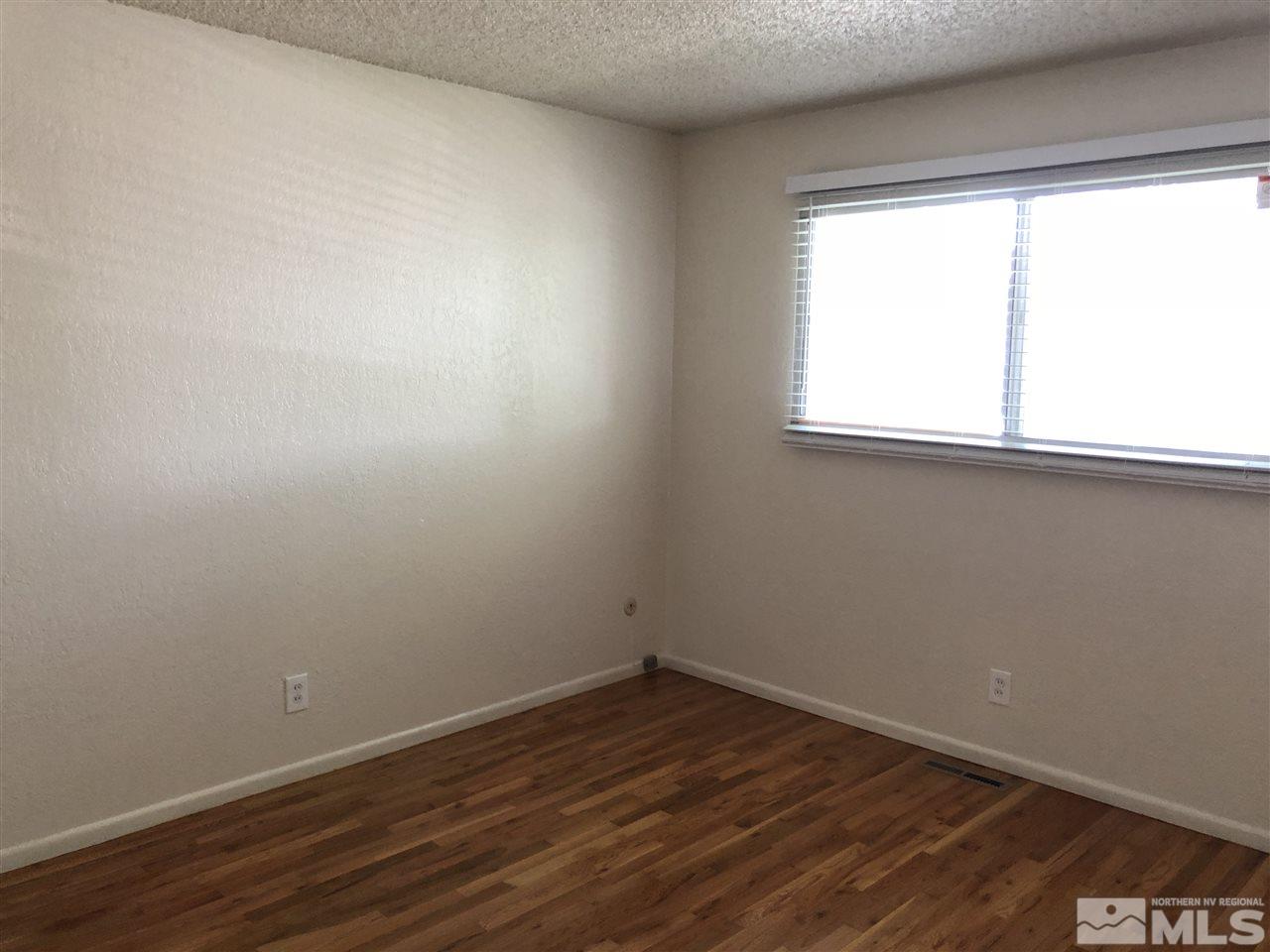 617 James Lane Reno, NV 89503 - Photo 8 of 15 wooden floor in an empty room with a window