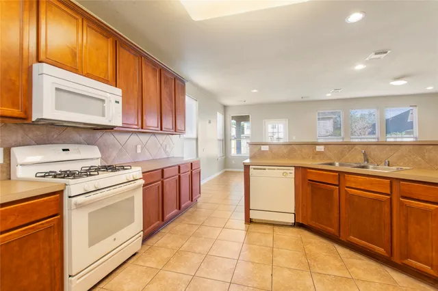 a kitchen with a stove top oven sink and cabinets