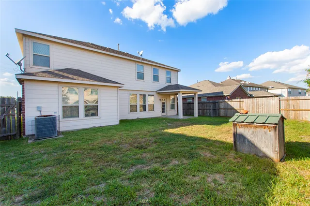 a view of a house with a yard and sitting area