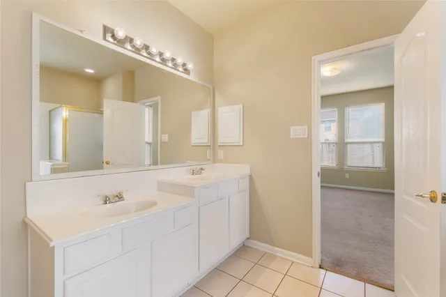 a spacious bathroom with a sink a mirror and a shower