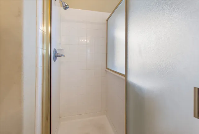 a bathroom with a glass shower door