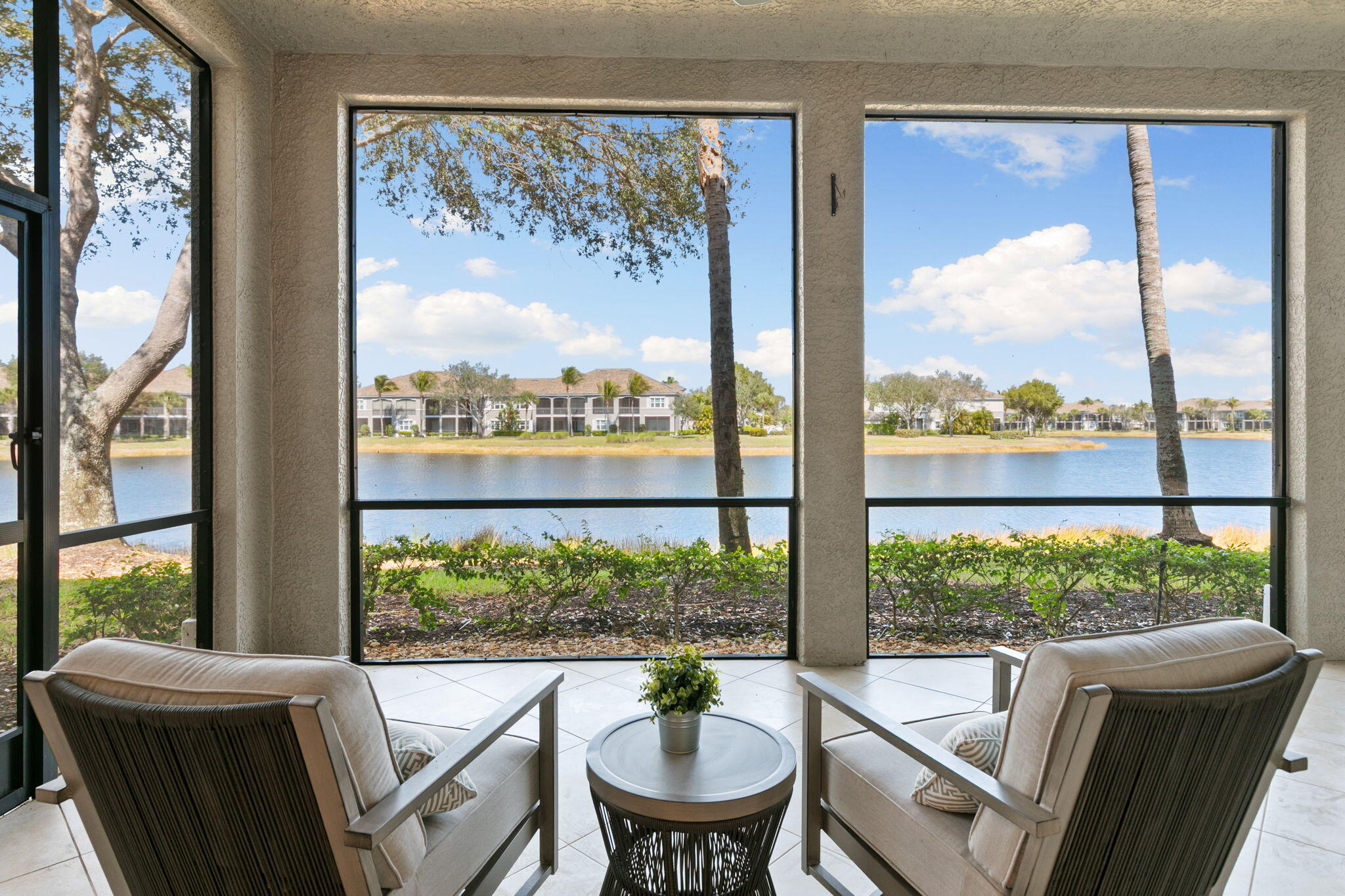 9213 Museo Circle, Unit 103 Naples, FL 34114 - Photo 23 of 47 a view of a city from a dining room with large windows and outside view