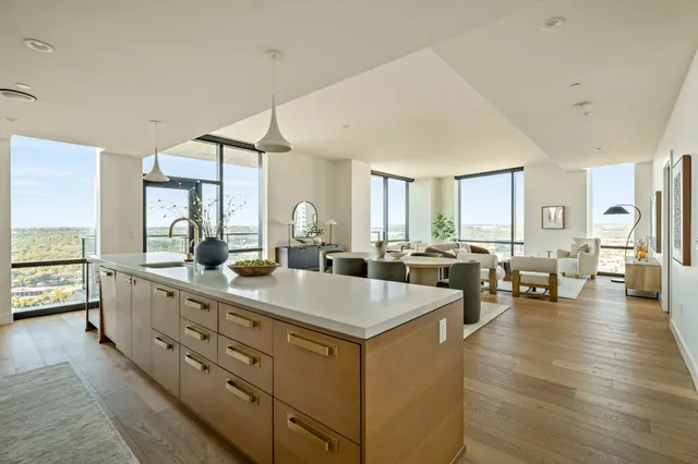 a view of living room with granite countertop lots of white furniture