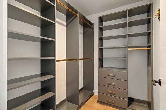 a view of walk in closet with empty racks