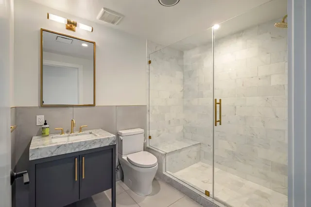 a bathroom with a toilet sink and shower