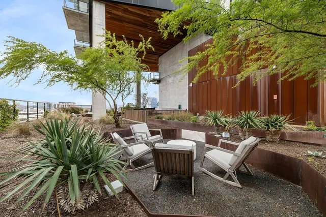 a view of a chairs and table in a backyard