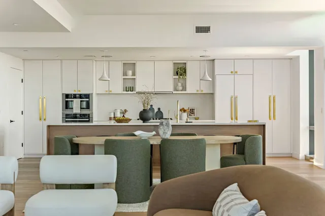 a living room with furniture and a kitchen
