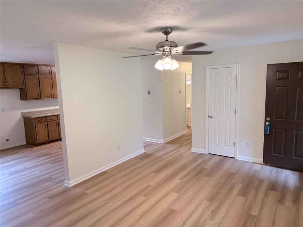 185 Roberts Road Covington, GA 30016 - Photo 8 of 25 a view of empty room with wooden floor and ceiling fan