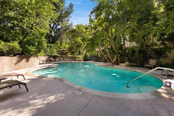 a view of a swimming pool with a yard