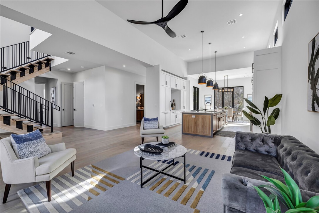 a living room with furniture and a chandelier