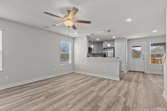 a view of a kitchen with a dishwasher cabinets and wooden floor