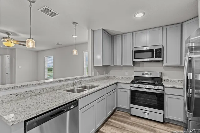 a kitchen with a sink stove and microwave