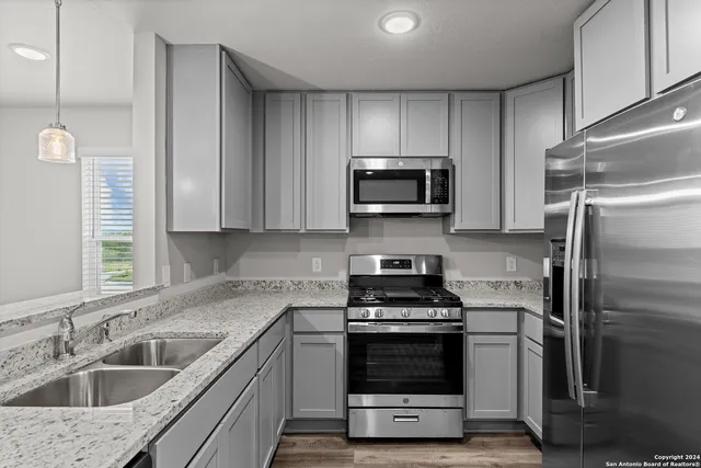 a kitchen with a sink stove and refrigerator