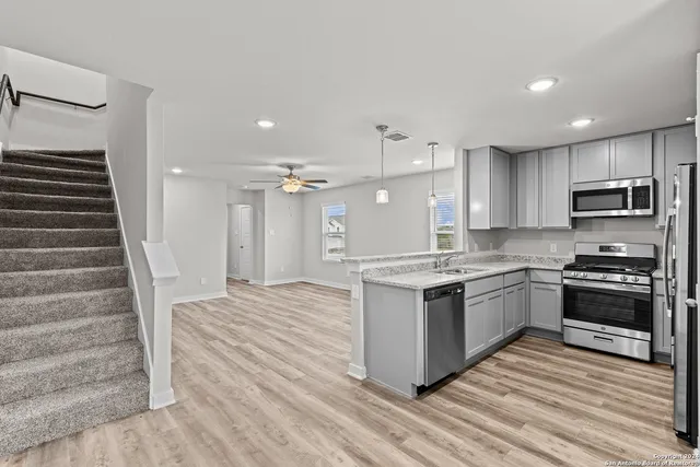 a kitchen with stainless steel appliances granite countertop a stove and a sink