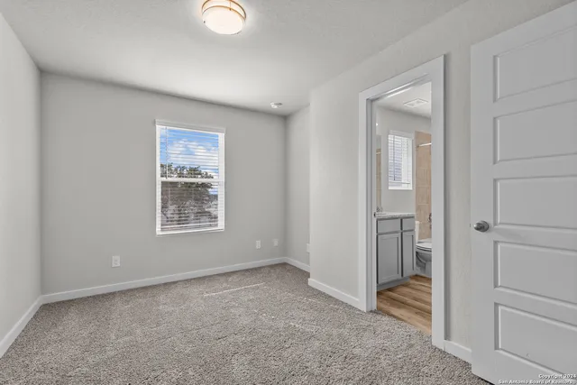 an empty room with windows and closet
