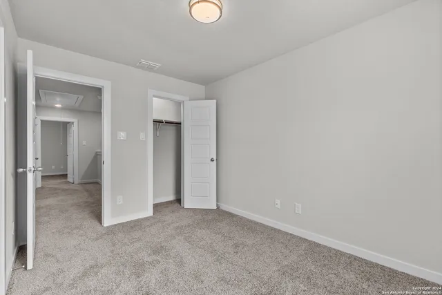an empty room with closet area